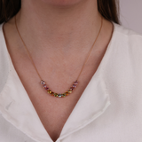 18ct rose gold multicolour tourmaline necklace worn around the neck showing a lively mix of colour.