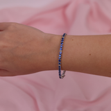 18ct white gold blue sapphire and diamond bracelet worn on the wrist showing deep blue colour and sparkle.