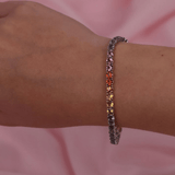 Detail of 18ct white gold sapphire bracelet showing the polished finish and colourful stones.