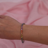 18ct white gold multicoloured sapphire bracelet worn on the wrist showing a burst of colour.