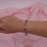 18ct white gold ruby and diamond bracelet worn on the wrist showing rich red colour and sparkle.