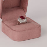 18ct white gold halo flower style ring featuring natural oval ruby and diamond detailing available at York Jewellers Penrith and Warriewood (Sydney).