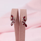 18ct white gold leaf style drop stud earrings featuring natural rubies and round brilliant cut diamonds available at York Jewellers Penrith and Warriewood (Sydney).