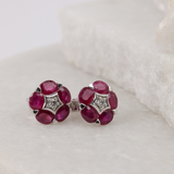 18ct white gold ruby stud earrings with claw set oval rubies and diamond details showing fine jewellery craftsmanship available at York Jewellers Penrith.