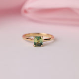18ct yellow gold solitaire ring featuring 1.03ct Madagascar parti sapphire in emerald cut four-claw setting, available at York Jewellers Penrith.