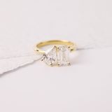 Pear shape and emerald cut diamond ring side profile yellow gold setting York Jewellers.