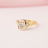 Collette engagement ring featuring cushion cut centre diamond yellow gold band.