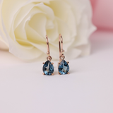 Rose gold shepherd hook earrings featuring deep blue pear-cut London topaz stones, offering a refined and sophisticated contrast - York Jewellers Warriewood.
