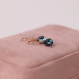 Elegant 9ct rose gold earrings with pear-shaped London blue topaz, secured in claw settings and suspended from classic shepherd hooks - York Jewellers Sydney.