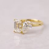 Elegant pear and emerald cut diamond engagement ring in yellow gold Australia.