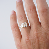 Close up pear shape and emerald cut diamond ring yellow gold Sydney jeweller.