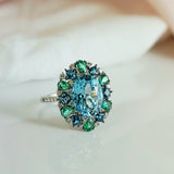 Sky Blue Topaz, Emerald & London Blue Topaz Fancy Halo Ring