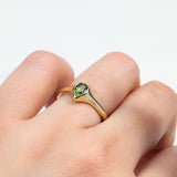9ct yellow gold Ingrid Pear Ring worn on hand showing shifting, multi-coloured parti sapphire.