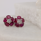Delicate flower-design ruby and diamond stud earrings available at York Jewellers Penrith and Warriewood (Sydney). 
