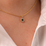 The 'Clarissa' 18ct Yellow Gold Necklace with Teal Sapphire and Diamonds (shown on-body) is available at York Jewellers Penrith. 
