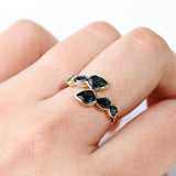 9ct yellow gold Ariel Ring worn on hand showing the flowing wrap design and graduated blue sapphires.