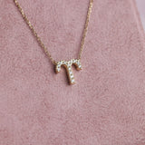 Close-up of 9ct yellow gold Aries pendant showcasing 13 carcelated round brilliant cut diamonds (0.07ct total) available at York Jewellers Penrith.