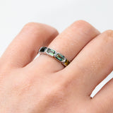 Close-up of 9ct white gold ring showcasing a row of emerald cut natural Australian sapphires in multiple colours, available at York Jewellers Penrith.