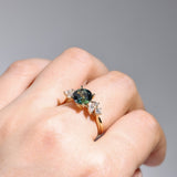 18ct yellow gold Aurelia Ring worn on hand showing shifting, multi-coloured parti sapphire and diamond accents.