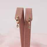 Modern 9ct yellow gold bezel set oval lab grown diamond huggie drop earrings available at York Jewellers in Penrith and Warriewood, Sydney.