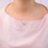 9ct yellow gold Capricorn diamond pendant worn at the collarbone showing the sea goat symbol and diamond detail.