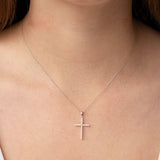 9ct white gold diamond cross pendant worn at the collarbone showing full-length sparkle, available at York Jewellers Penrith. 