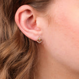 On-ear close-up of 0.10ct natural round brilliant cut diamonds in 9ct yellow gold carcelated stud earrings available at York Jewellers Penrith and Warriewood.