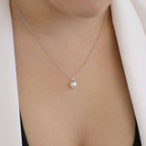 9ct white gold diamond and pearl necklace worn at the collarbone, ideal for layering or wearing alone, available at York Jewellers Penrith.