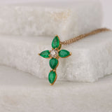 Elegant 18ct yellow gold emerald cross pendant available from Sydney fine jeweller York Jewellers featuring natural emeralds and diamond detailing.