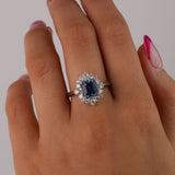 Close-up of 18ct white gold ring showcasing 1.95ct natural emerald cut blue sapphire and diamond halo detail available at York Jewellers Penrith.