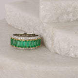 Profile of 18ct white and yellow gold ring showing emerald cut natural emeralds and diamond detailing.