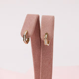 Close detail of 9ct yellow gold geometric huggie hoops featuring linear baguette diamond sparkle available at York Jewellers Penrith and Warriewood (Sydney).
