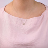 9ct yellow gold Gemini diamond pendant worn at the collarbone showing the twins symbol and diamond detail.