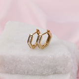 Elegant geometric 9ct yellow gold huggie hoop earrings with natural baguette cut diamonds instore at York Jewellers Penrith.