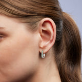 On-ear image of 9ct white gold huggie earrings showcasing princess cut natural Australian teal sapphires, available at York Jewellers Penrith.