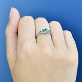 18ct white gold Kyra Ring worn on hand showing a varied arrangement of natural sapphire colour and diamond sparkle.