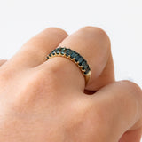9ct yellow gold Lennon Ring worn on hand showing the row of baguette teal sapphires and shifting colour.