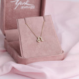 Close-up of 9ct yellow gold Leo pendant showcasing 17 carcelated round brilliant cut diamonds (0.10ct total) available at York Jewellers Penrith.