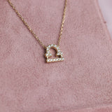 Close-up of 9ct yellow gold Libra pendant showcasing 21 carcelated round brilliant cut diamonds (0.14ct total) available at York Jewellers Penrith.