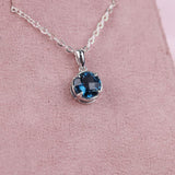 Close-up of 9ct white gold solitaire pendant showcasing 1.78ct natural round London blue topaz available at York Jewellers Penrith.