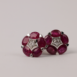 Luxury 18ct white gold ruby earrings featuring natural rubies with subtle round brilliant cut diamond sparkle available at York Jewellers Penrith. 