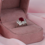 Detail shot of claw set marquise diamonds (0.45ct total) and pear shaped diamonds (0.73ct total) forming a floral halo around a natural ruby.