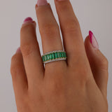 18ct white and yellow gold emerald ring worn on hand showing rich green gemstones and two-tone gold design.