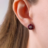 18ct white gold ruby and diamond stud earrings worn on ear showing vibrant red gemstone colour and sparkle available at York Jewellers Penrith. 