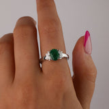 Close-up of 18ct white gold ring showcasing 1.18ct natural oval shaped emerald and tapered baguette diamond detail available at York Jewellers Penrith.