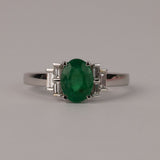 Elegant 18ct white gold emerald ring available from Sydney fine jeweller York Jewellers featuring natural oval emerald and tapered baguette diamonds.