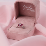 Close-up of 18ct white gold ruby flower ring showcasing 1.64ct total natural oval rubies and diamond centre detail available at York Jewellers Penrith. 