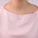 9ct yellow gold Pisces diamond pendant worn at the collarbone showing the fish symbol and diamond detail.