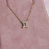 Close-up of 9ct yellow gold Pisces pendant showcasing 19 carcelated round brilliant cut diamonds (0.10ct total) available at York Jewellers Penrith.