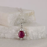 Elegant 18ct white gold ruby halo pendant available from Sydney fine jeweller York Jewellers featuring natural ruby and diamond detailing.